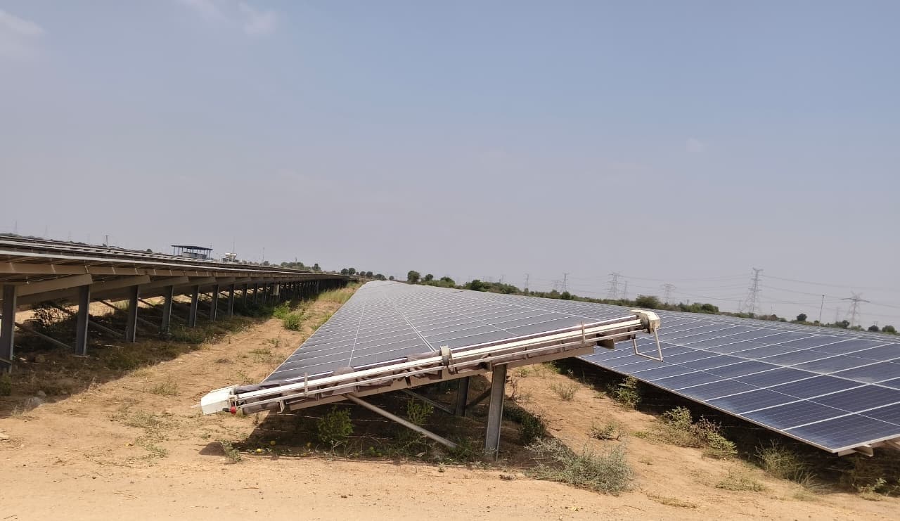 Taypro semi-automatic cleaning robots installed at a 50 MW solar plant in Gujarat, optimizing O&M efficiency for a 50.51 MW utility-scale solar project.